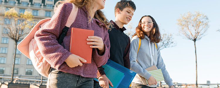 Kids walking outside at school showing off pieces from their capsule wardrobe