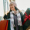 woman in winter clothes carrying christmas presents through mall for a blog about the best christmas shopping in bend